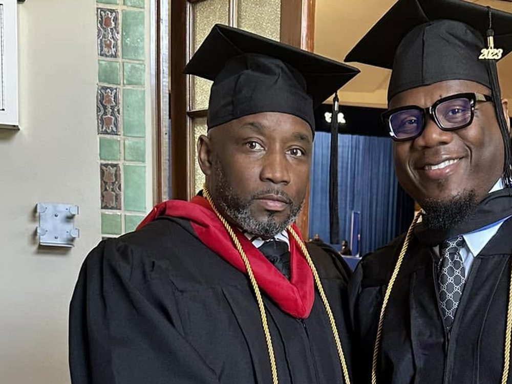 Apostle Vincent L. Greaves Sr. at commencement in academic regalia, wearing the red doctoral hood.